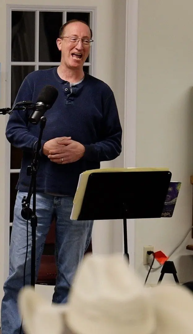Open Mic emcee smiling in the performance space
